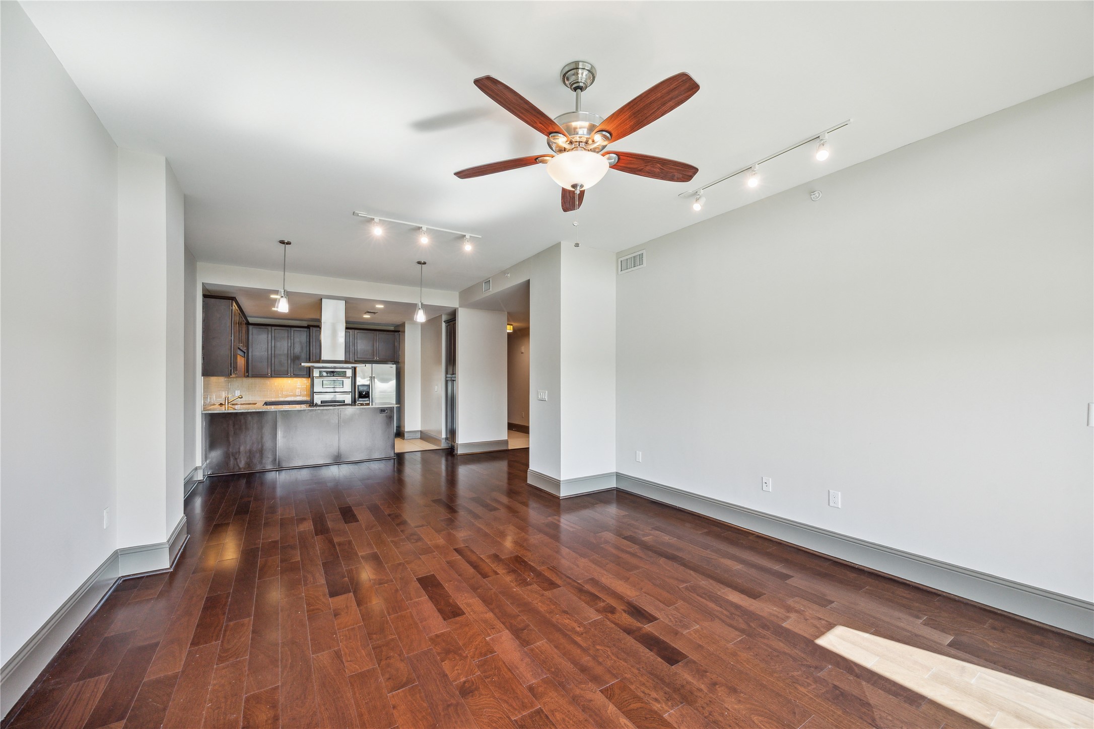 9870 Gaylord Drive, Unit 518 Houston, TX 77024 - Photo 7 of 34 wooden floor in an empty room with a window