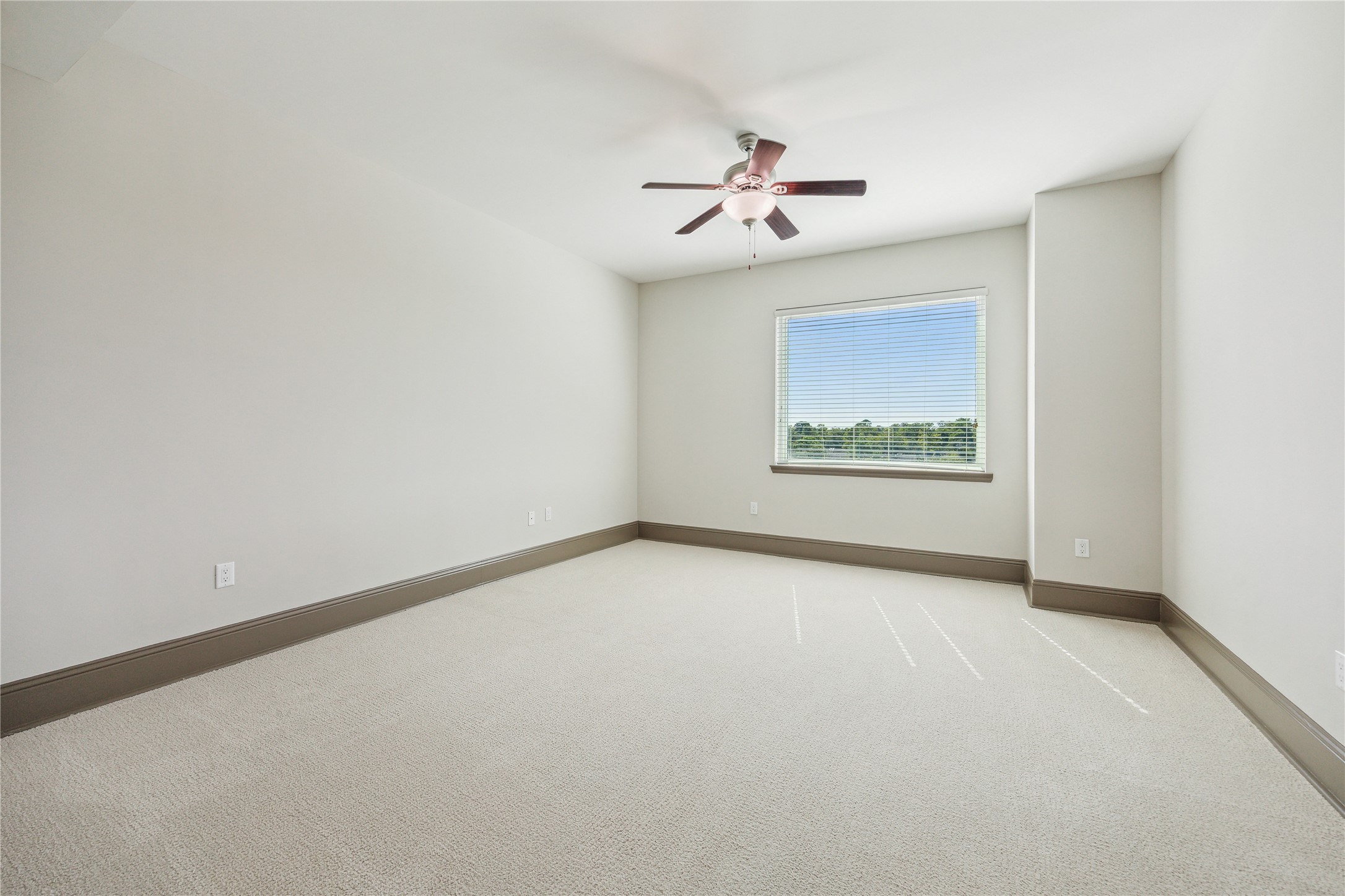 9870 Gaylord Drive, Unit 518 Houston, TX 77024 - Photo 10 of 34 an empty room with windows and fan