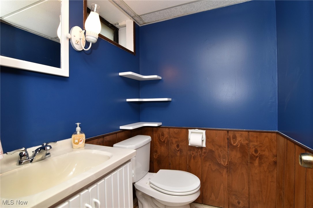 317 Nobottom Road Berea, OH 44017 - Photo 40 of 49 Bathroom with vanity, toilet, and wooden walls