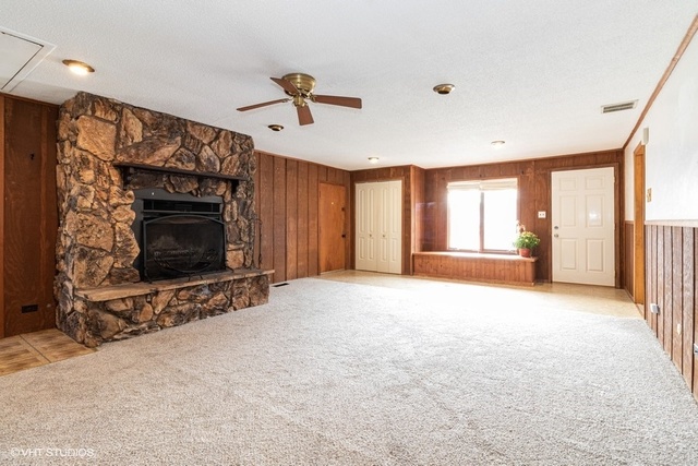 10759 Oak Avenue Chicago Ridge, IL 60415 - Photo 2 of 19 a view of an empty room with a fireplace and a window