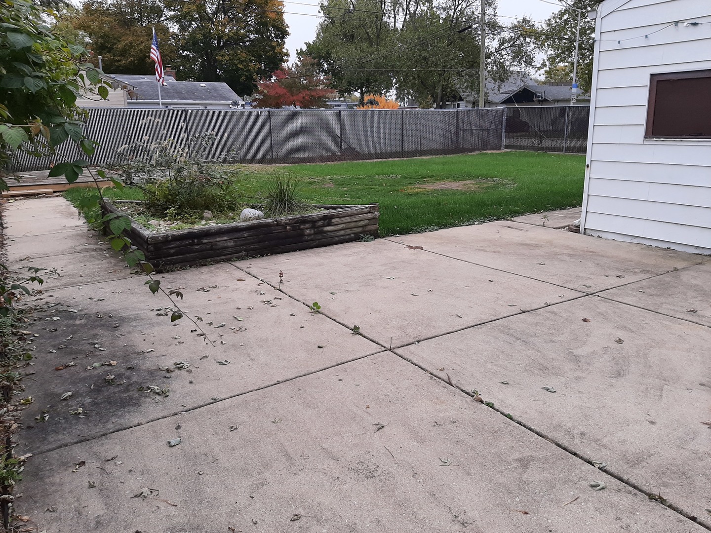 10759 Oak Avenue Chicago Ridge, IL 60415 - Photo 14 of 19 a view of a back yard with flower plants and wooden fence