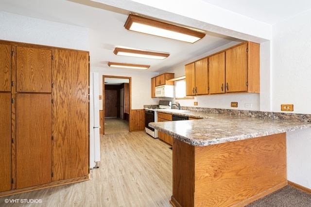 10759 Oak Avenue Chicago Ridge, IL 60415 - Photo 6 of 19 a kitchen with stainless steel appliances granite countertop wooden cabinets a sink and a refrigerator