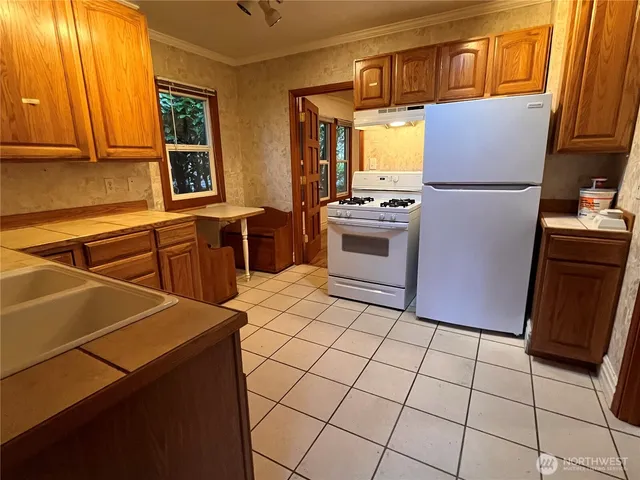 a kitchen with stainless steel appliances a refrigerator sink and cabinets