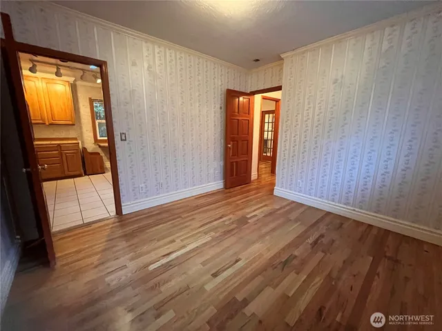 a view of an empty room with glass door