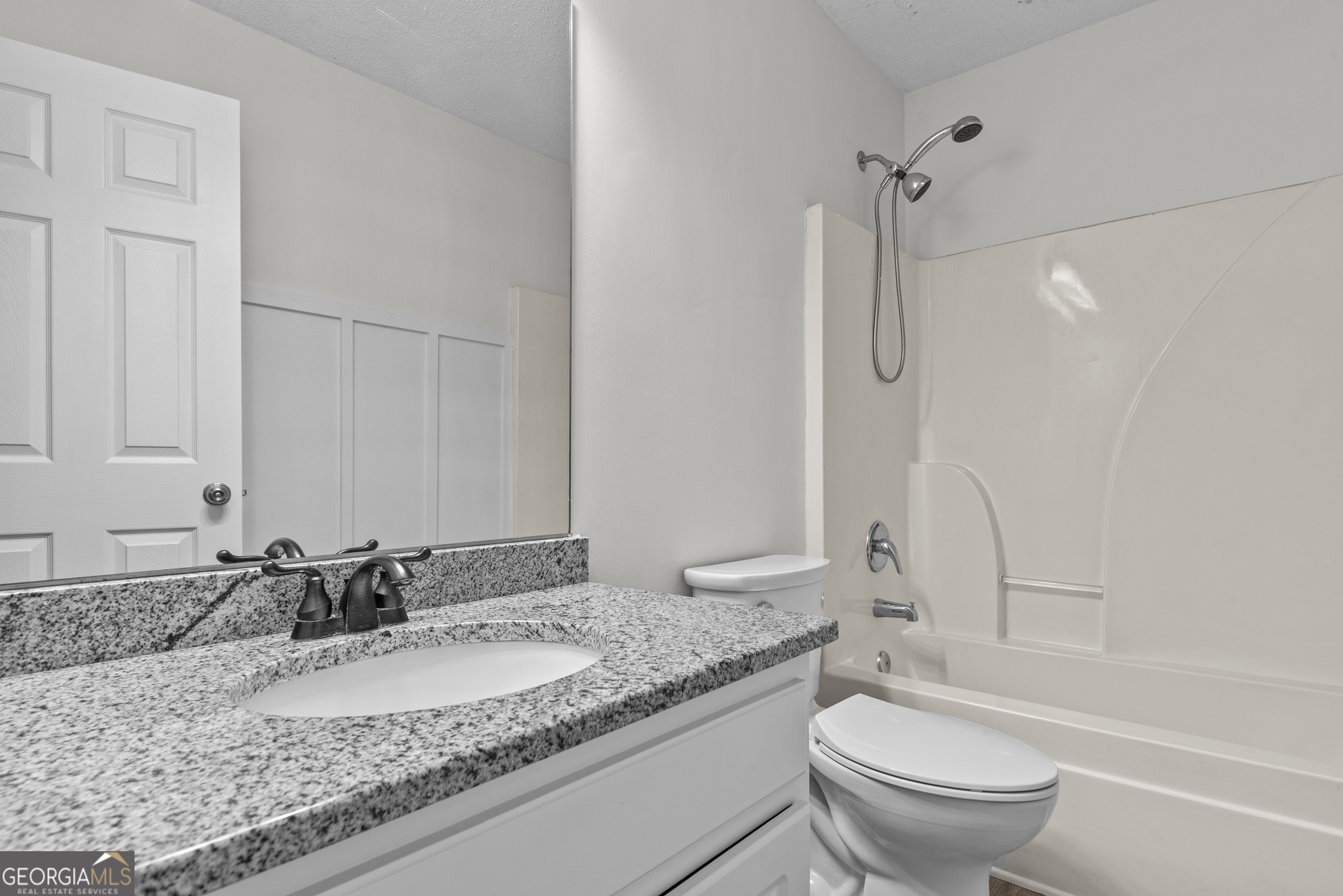 427 Bridges Way Winterville, GA 30683 - Photo 25 of 43 a bathroom with a granite countertop sink and a mirror