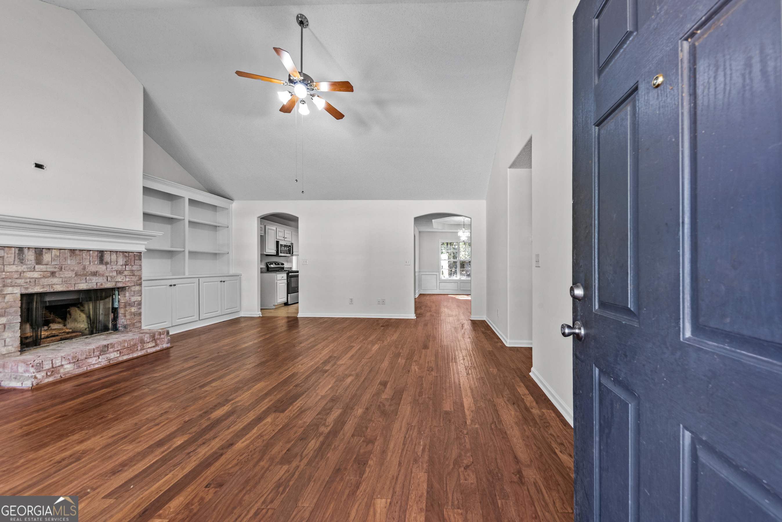 427 Bridges Way Winterville, GA 30683 - Photo 5 of 43 a view of a livingroom with a fireplace a ceiling fan and windows