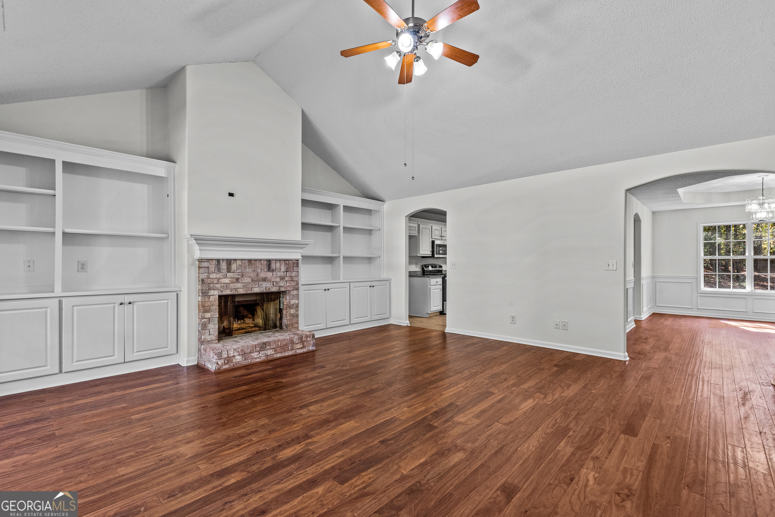 427 Bridges Way Winterville, GA 30683 - Photo 6 of 43 a view of empty room with wooden floor and fireplace