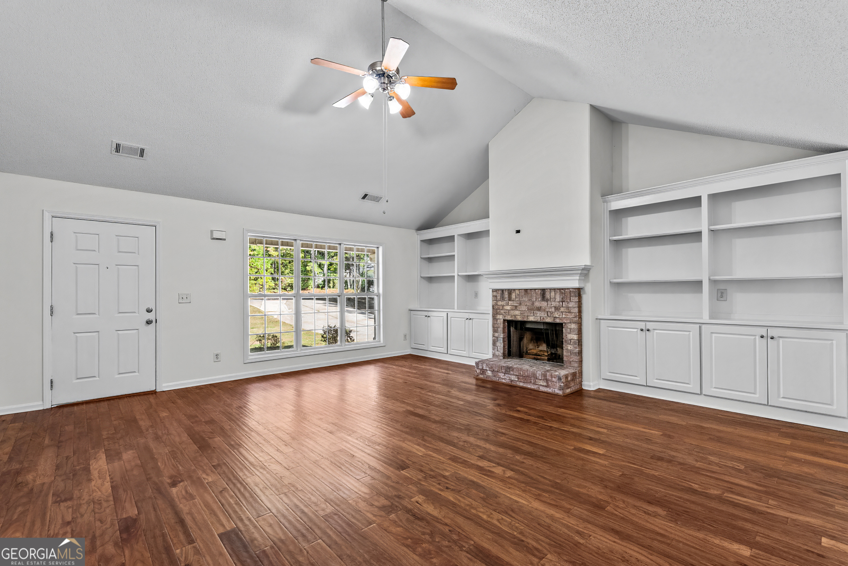 427 Bridges Way Winterville, GA 30683 - Photo 8 of 43 a view of an empty room with a fireplace and window