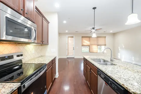 a kitchen with stainless steel appliances granite countertop a sink and stove