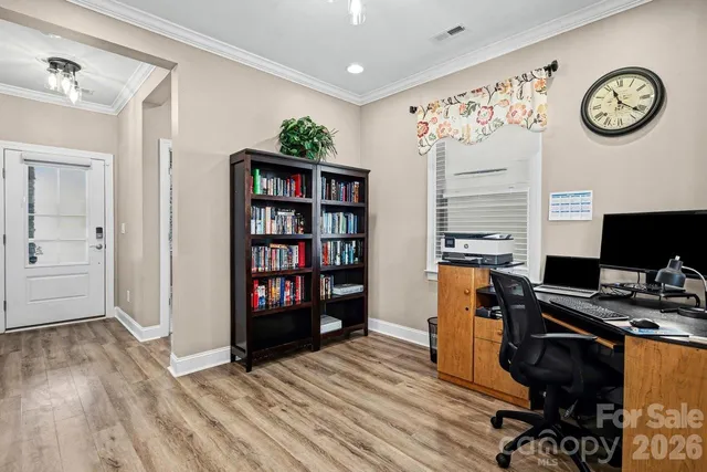 a view of a workspace with furniture and wooden floor