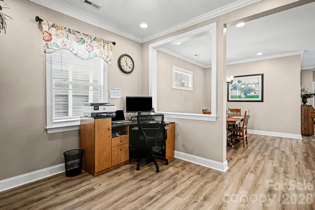 a view of a workspace with furniture and a window
