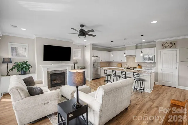 a living room with furniture a fireplace and a flat screen tv