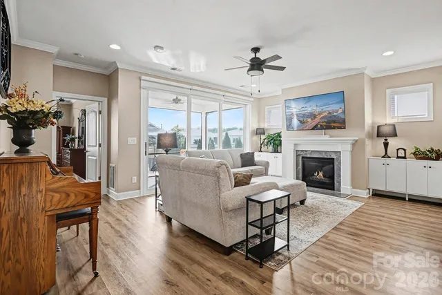 a living room with furniture a fireplace and a flat screen tv