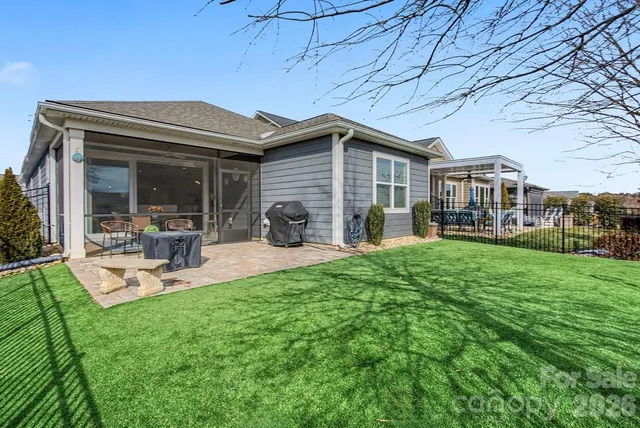 a view of a house with backyard porch and sitting area