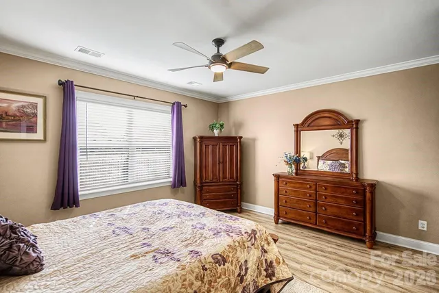 a bedroom with a bed dresser and a window