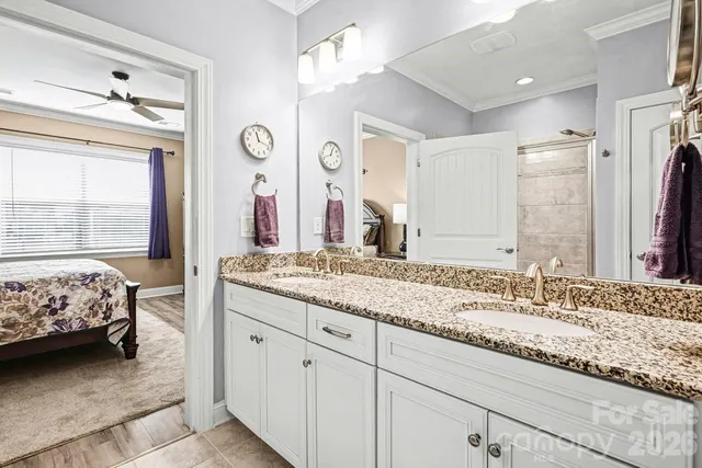 a spacious bedroom with a bed mirror and a window