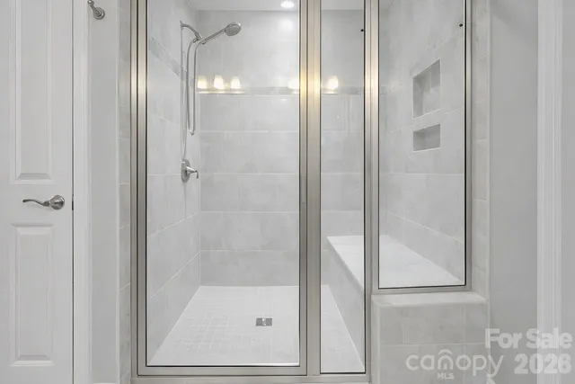 a bathroom with a glass shower door