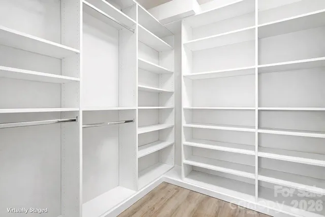 a view of walk in closet with empty racks