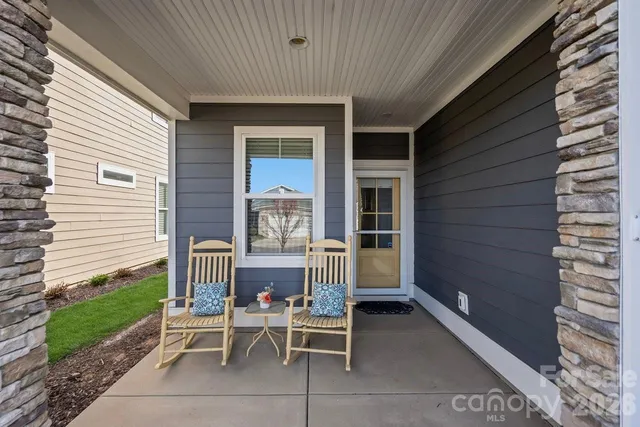 a view of a two chairs in the patio