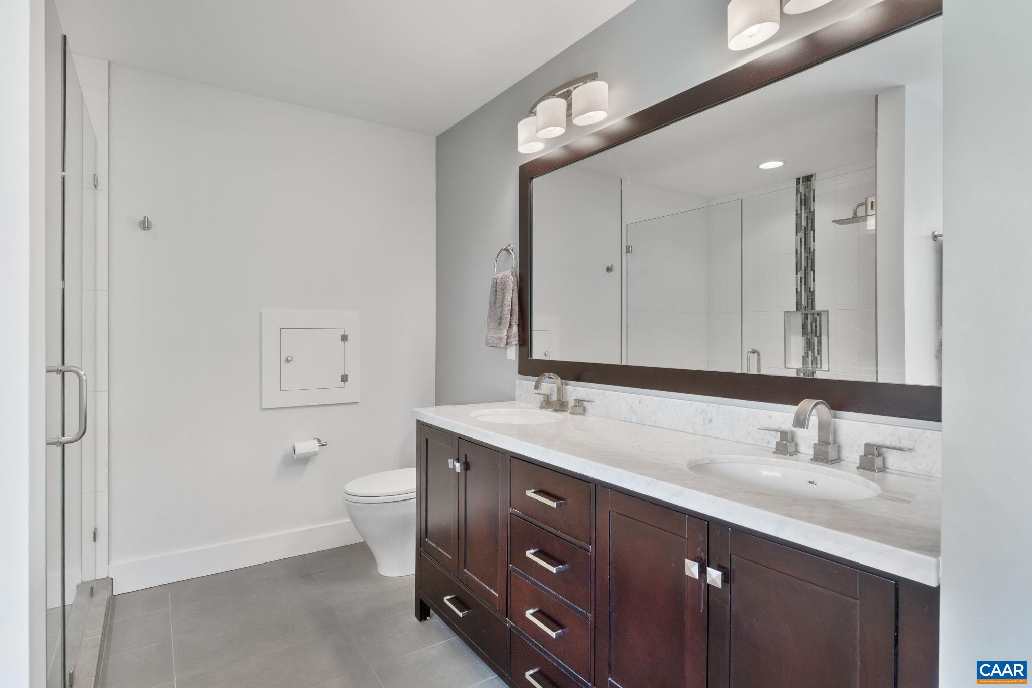 3457 Morgantown Road Charlottesville, VA 22903 - Photo 45 of 64 a bathroom with a double vanity sink and mirror with toilet