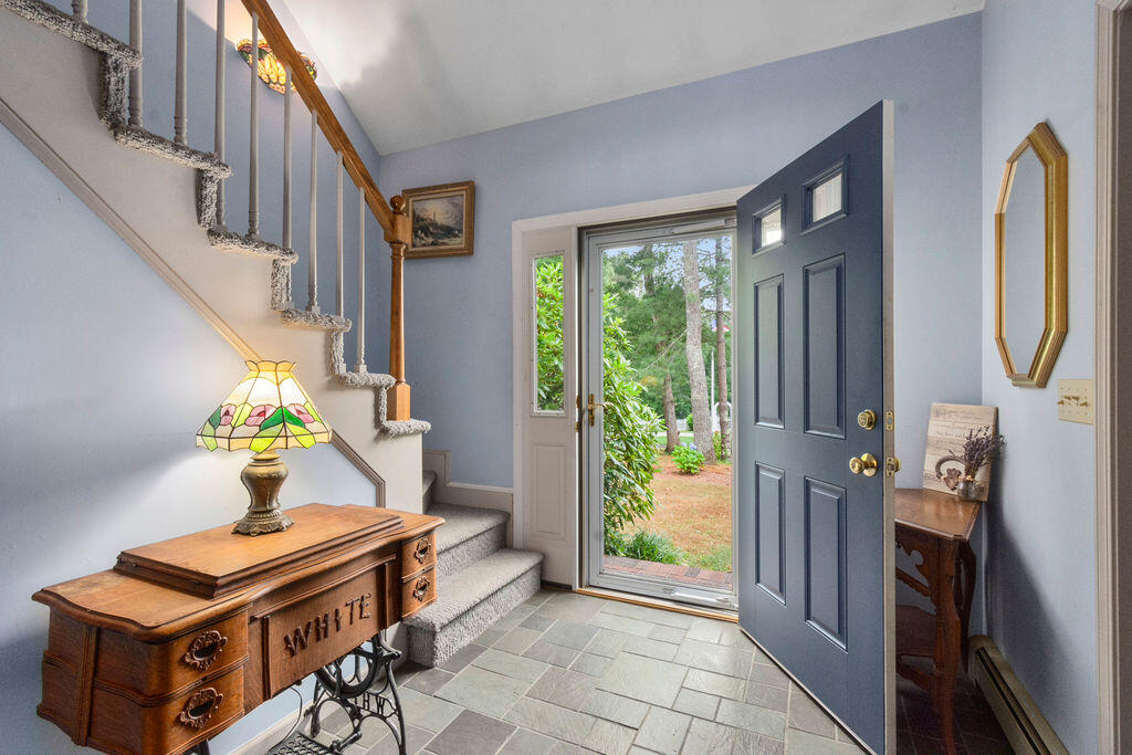 24 Indigo Lane Osterville, MA 02655 - Photo 11 of 84 a living room with furniture a fireplace and a chandelier