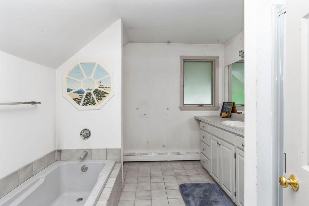 24 Indigo Lane Osterville, MA 02655 - Photo 32 of 84 a bathroom with a granite countertop sink a mirror and a bathtub