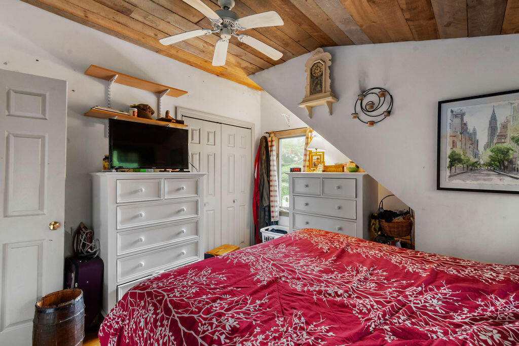 24 Indigo Lane Osterville, MA 02655 - Photo 57 of 84 a bedroom with a bed and a flat tv screen on dresser