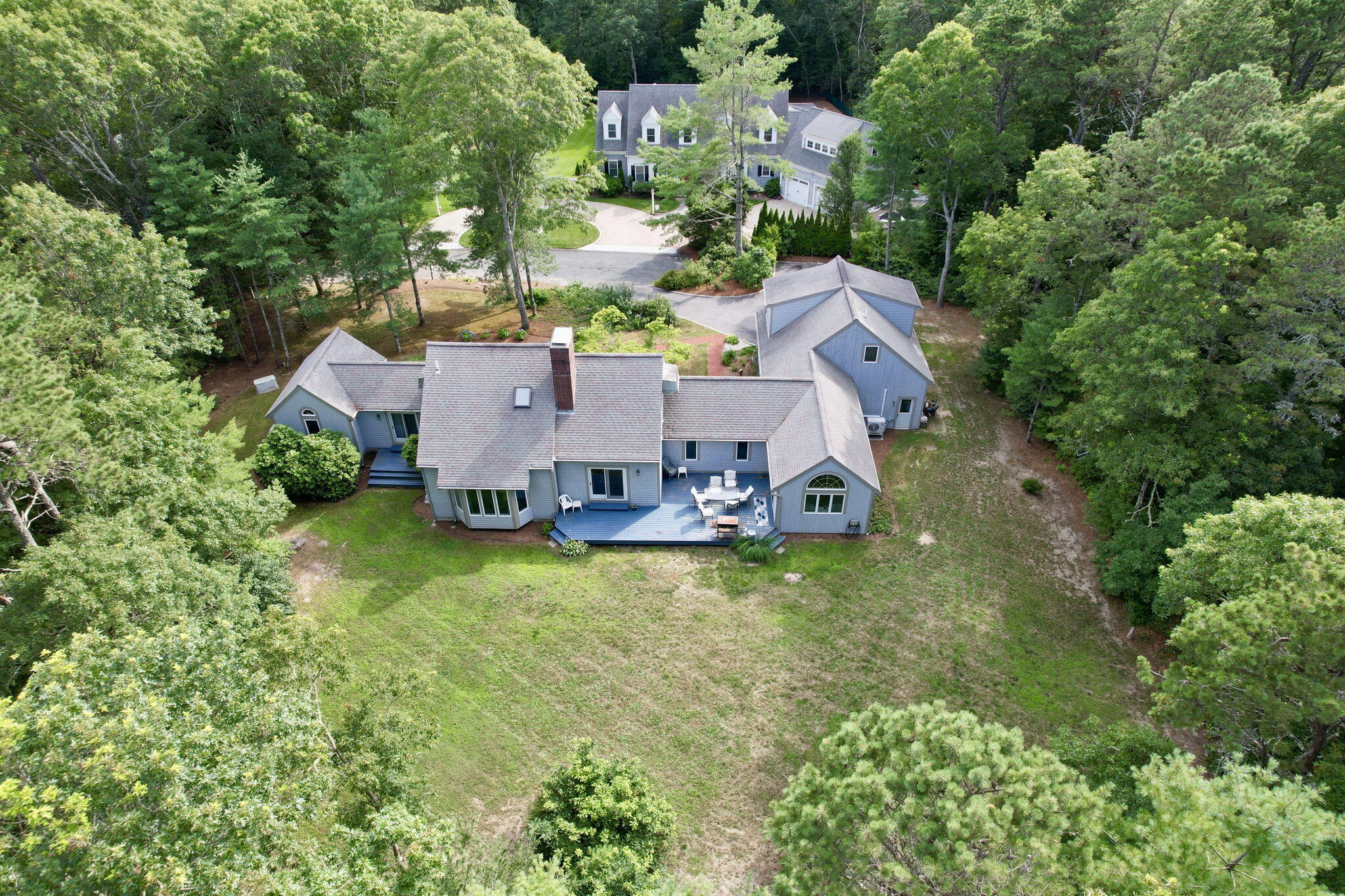 24 Indigo Lane Osterville, MA 02655 - Photo 78 of 84 an aerial view of a house with swimming pool and large trees