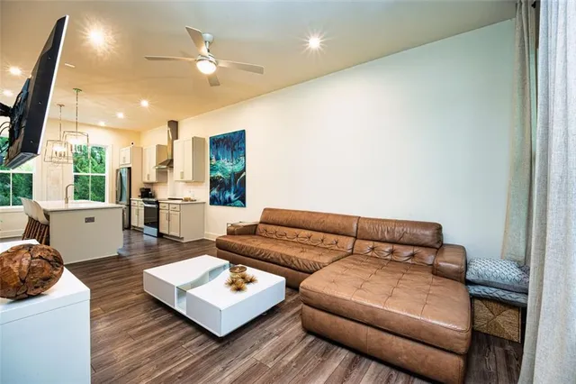 a living room with furniture and a wooden floor