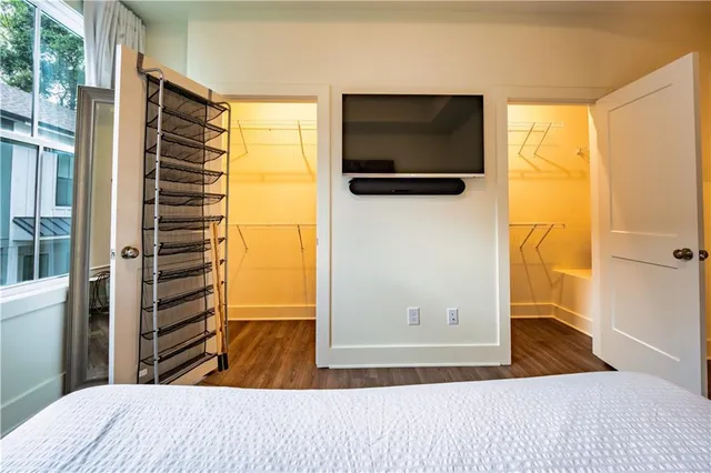 a bedroom with a bed and a television