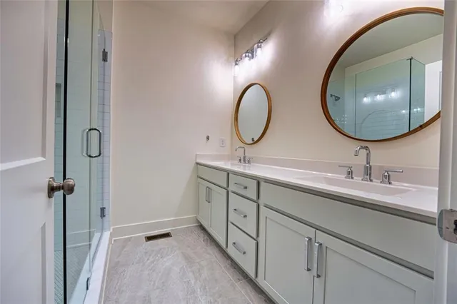 a bathroom with a double vanity sink and a mirror