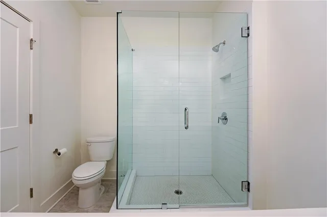 a bathroom with a shower and a toilet