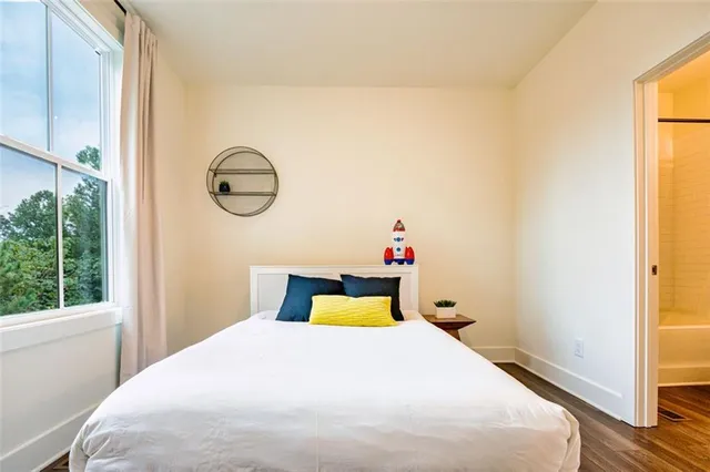 a bedroom with a bed and a window