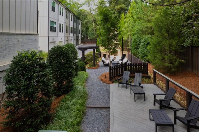 a view of a patio with couches table and chairs and potted plants