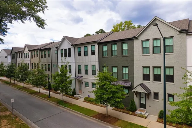 a front view of a residential houses with yard