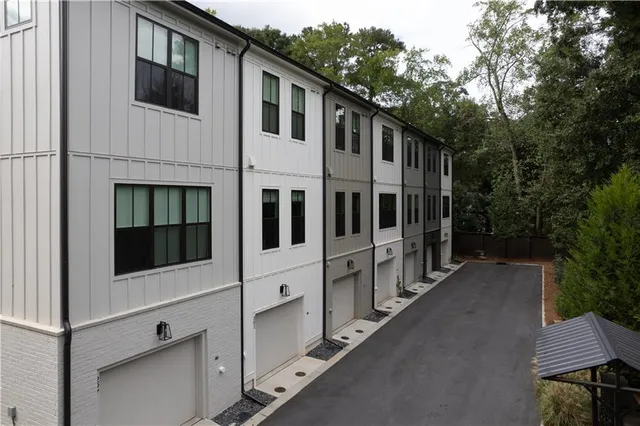 a view of white house with a yard