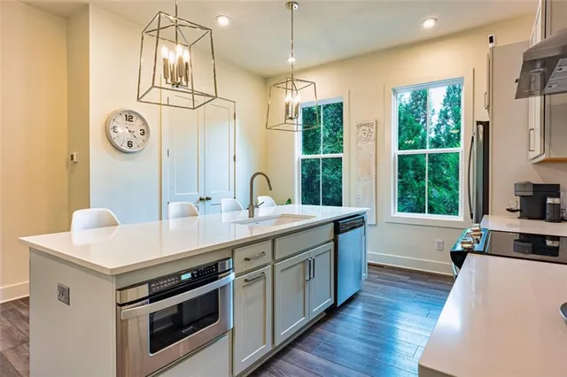 a kitchen that has a lot of cabinets and wooden floor