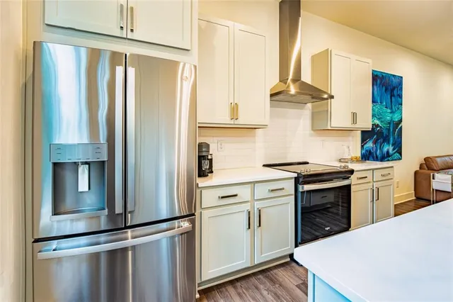 a kitchen with stainless steel appliances a refrigerator sink and cabinets