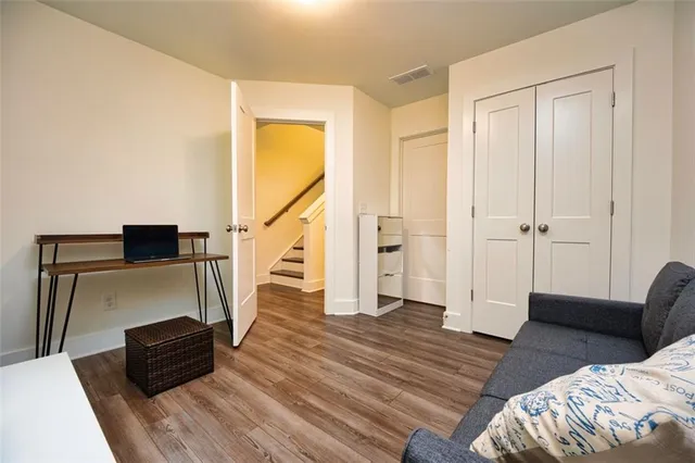 a view of a bedroom with furniture and wooden floor