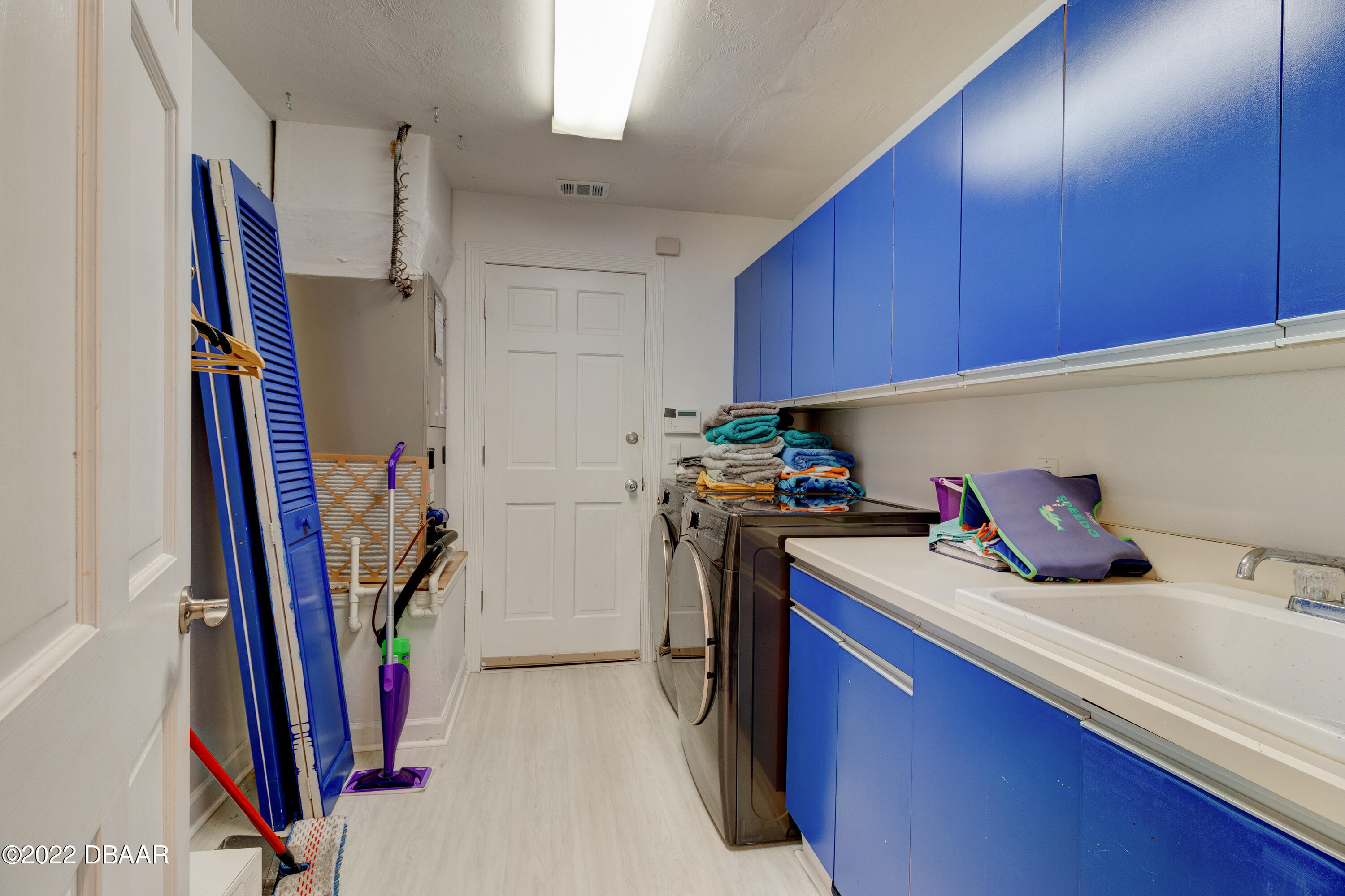 13 Bay Pointe Drive Ormond Beach, FL 32174 - Photo 14 of 44 a kitchen with a sink a refrigerator and washer