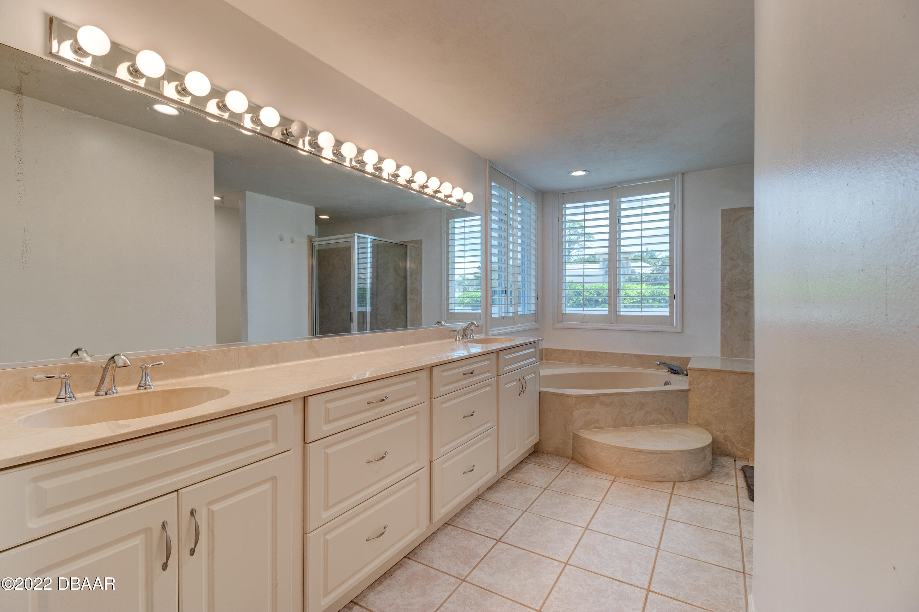 13 Bay Pointe Drive Ormond Beach, FL 32174 - Photo 16 of 44 a spacious bathroom with a granite countertop sink a toilet mirror and a bathtub
