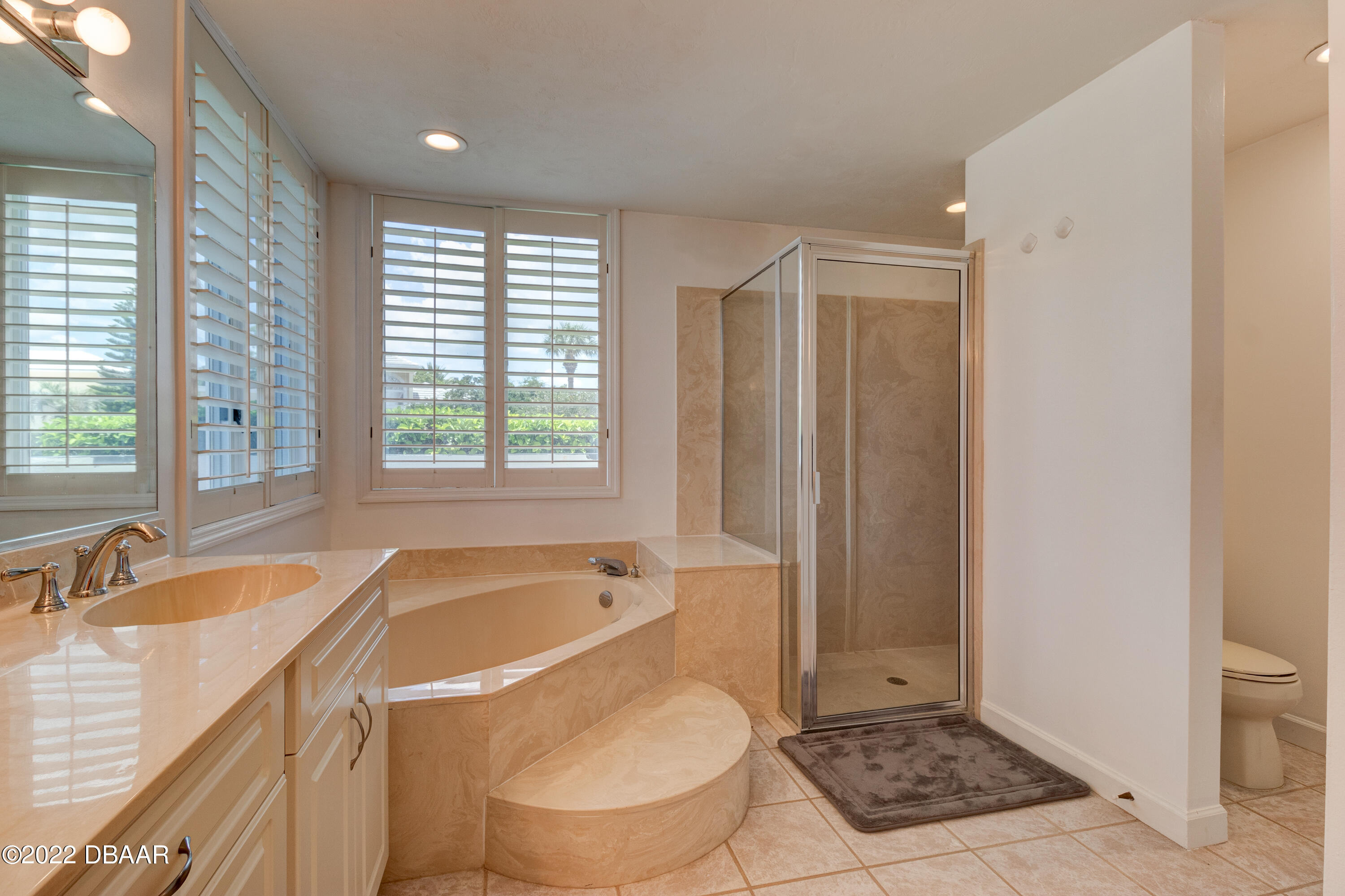 13 Bay Pointe Drive Ormond Beach, FL 32174 - Photo 17 of 44 a bathroom with a sink toilet and shower