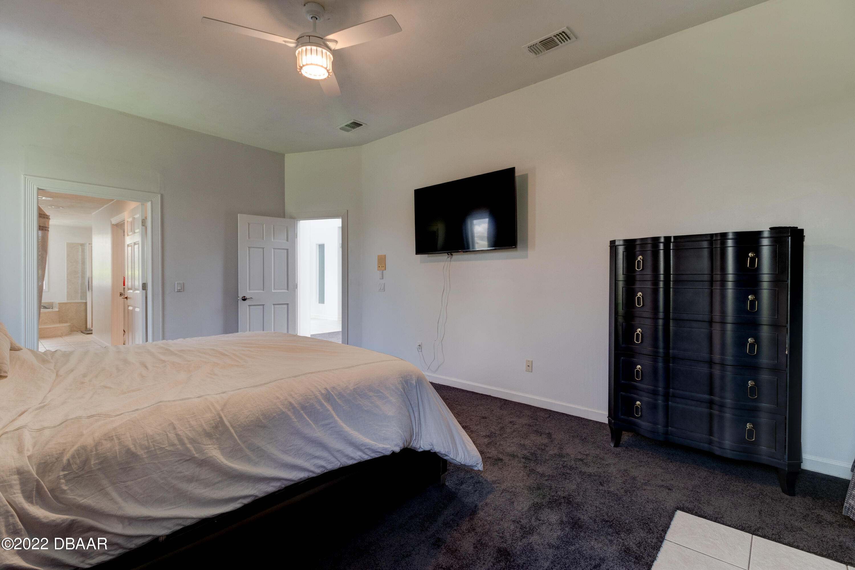 13 Bay Pointe Drive Ormond Beach, FL 32174 - Photo 19 of 44 a bedroom with a bed and a flat screen tv