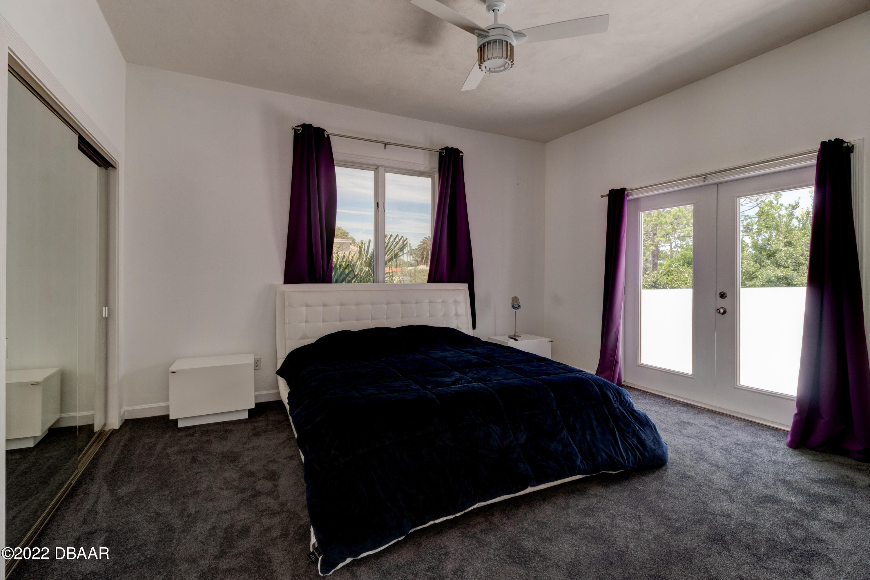 13 Bay Pointe Drive Ormond Beach, FL 32174 - Photo 21 of 44 a bedroom with a bed and a large window