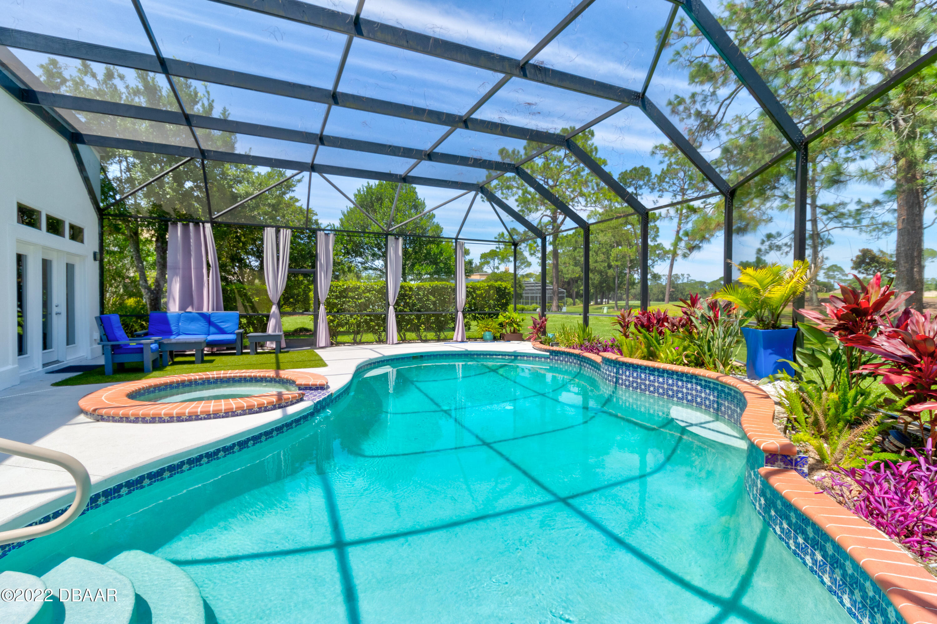13 Bay Pointe Drive Ormond Beach, FL 32174 - Photo 33 of 44 a view of a backyard with a table and chairs under an umbrella