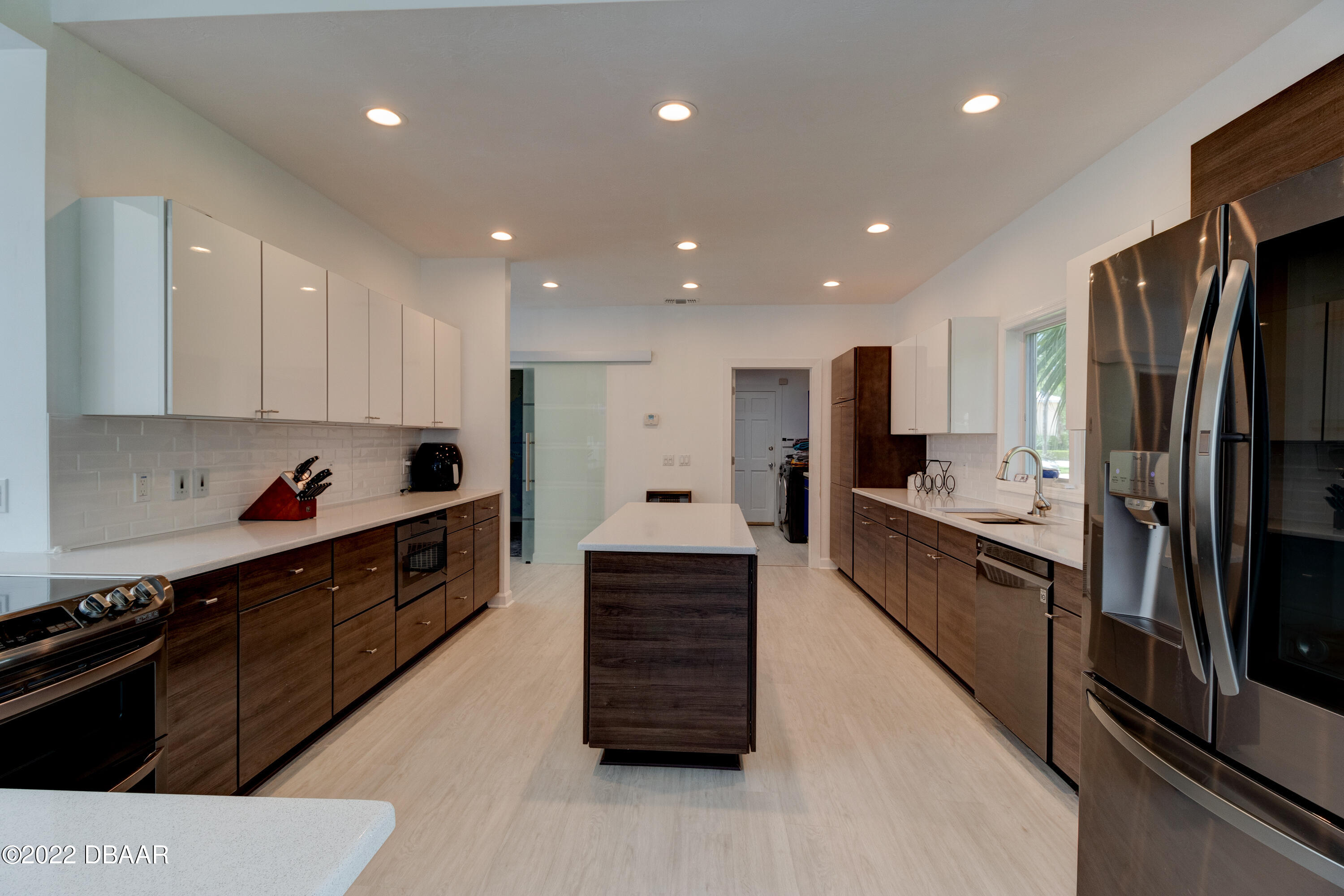 13 Bay Pointe Drive Ormond Beach, FL 32174 - Photo 8 of 44 a large kitchen with stainless steel appliances kitchen island granite countertop a stove a refrigerator a sink and dishwasher