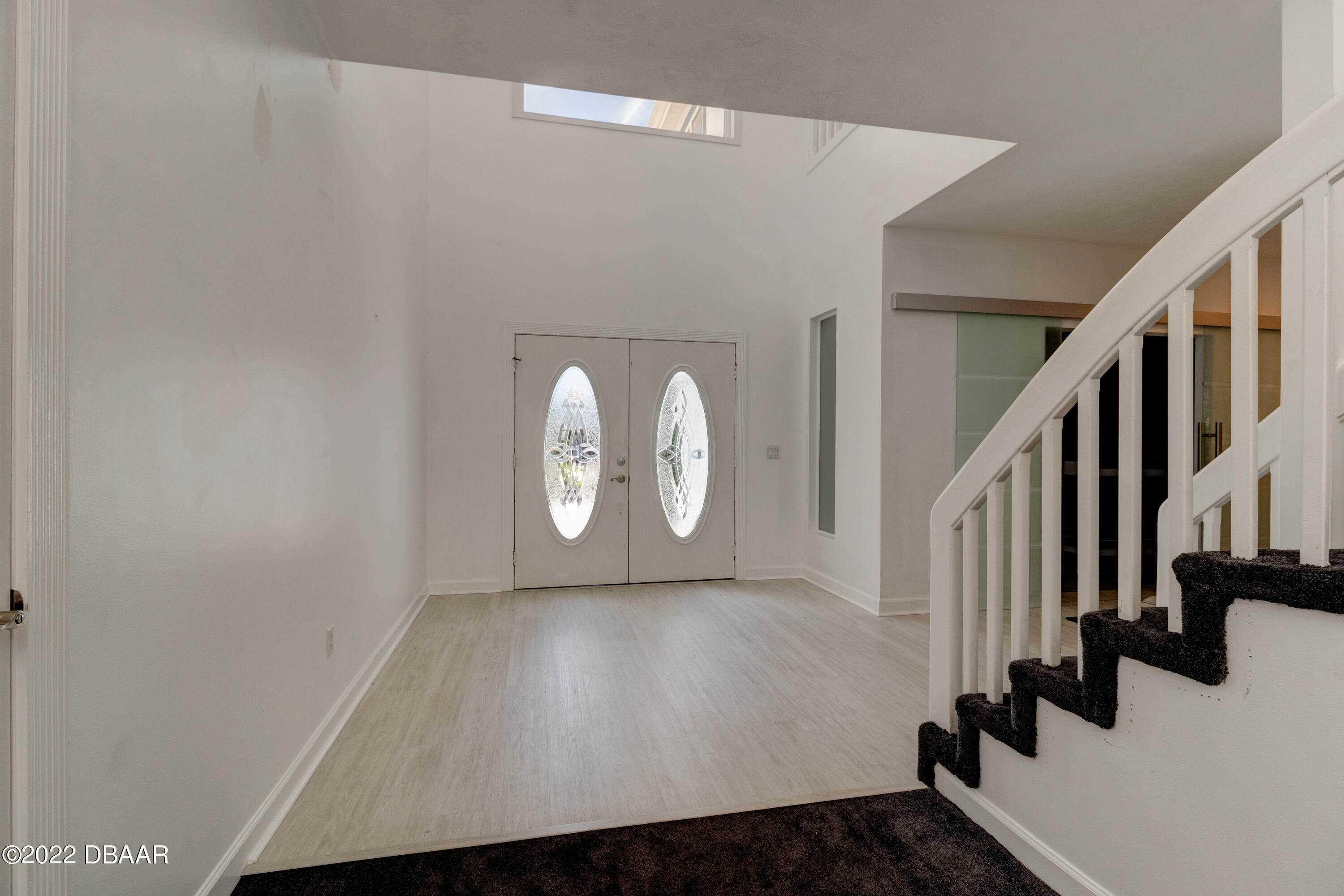 13 Bay Pointe Drive Ormond Beach, FL 32174 - Photo 10 of 44 a view of a livingroom with wooden floor and white walls