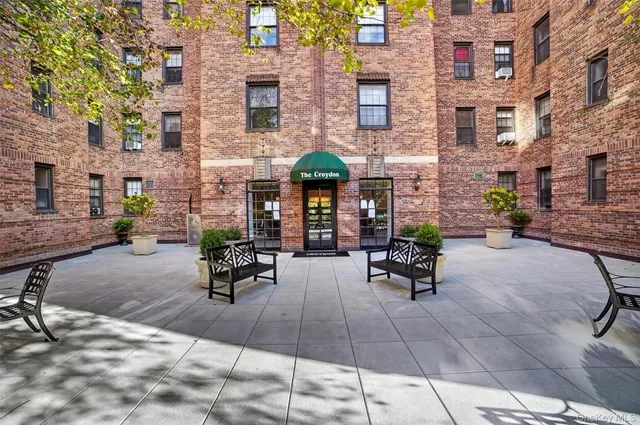 a view of a brick building with many windows