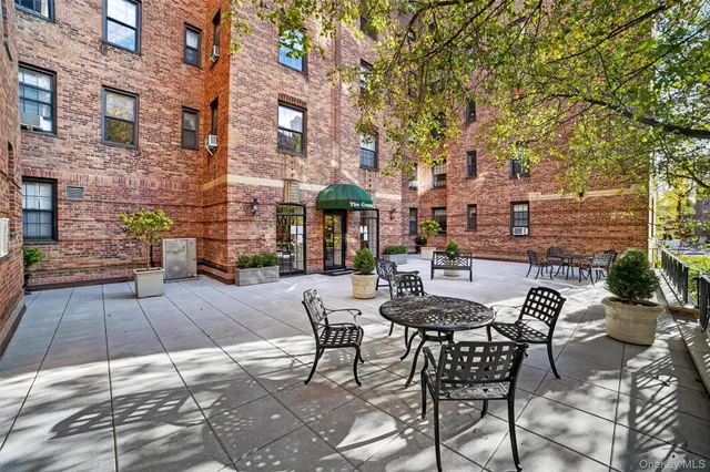 a view of a patio with table and chairs and potted plants