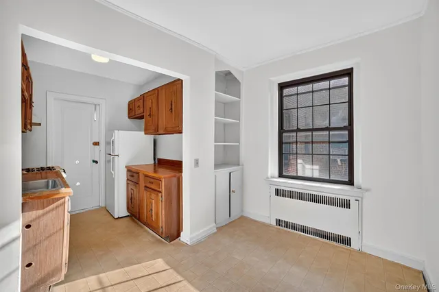 a view of a storage & utility room with closet window